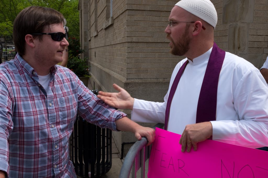 During the faceoff between the alliance of white nationalist and anti-fascist demonstrators in downtown Pikeville, Kentucky, Rob Musick, campus chaplain and religion instructor at the University of Pikeville talks with Brad Griffin, of Eufaula, Alabama, who runs the white nationalist website Occidental Dissent and is a member of the neo-confederate League of the South. “This is a classic example of Appalachian shaming,” said Musick, “with both sides coming from the outside thinking they know what’s best for us. We don’t need them; we can take care of ourselves.” Photo: 100 Days in Appalachia