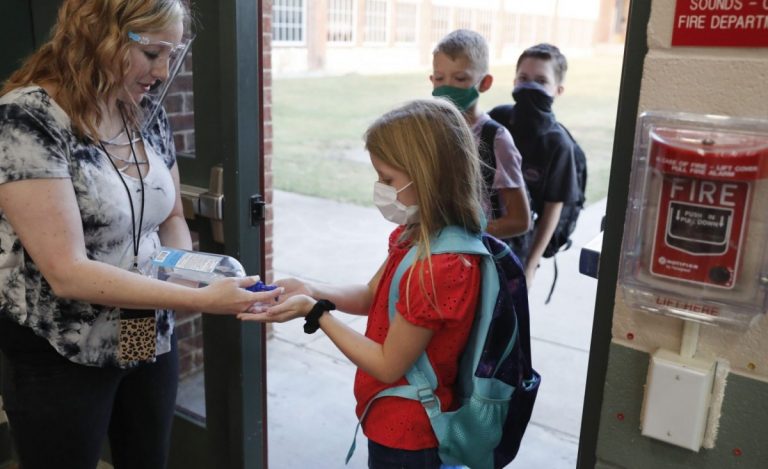 Students enter the classroom in Godley, Texas, on August 5. Godley is a town of approximately 1,000 residents about 30 miles southwest of Fort Worth. The school district is among the first to open in Texas for the fall term. Photo: AP Photo/ LM Otero