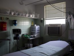 image of a hospital exam room with a window air conditioning unit
