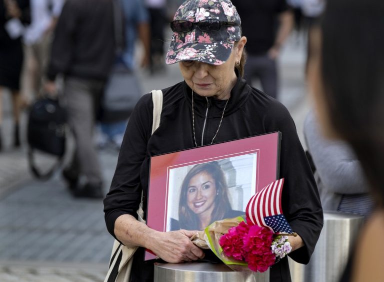 Connie Dray of West Virginia holds a photo Wednesday, Sept. 11, 2019, of her cousin Mary Lou Hague, who died in the World Trade Center attacks of Sept. 11, 2001, as she stands near One World Trade Center while ceremonies marking the 18th anniversary were underway nearby. This was Dray's first time at the ceremonies, saying it was on her list of important things to accomplish, as she also close with Hague's family. Photo: Craig Ruttle/AP Photo