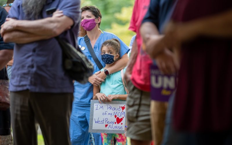 Dani Miller holds a sign during a rally to support unionization efforts outside West Penn hospital on August 3, 2021. Dani’s mother Sam, left, is a second-generation healthcare worker at West Penn. Photo: David Smith/100 Days in Appalachia