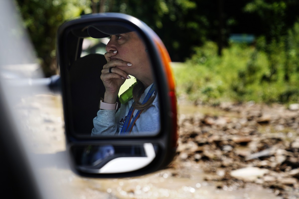 Kimberly Holley, a member of the Tennessee Task Force One, looks out the window at the devastation massive flooding has caused on Wednesday, Aug. 3, 2022, near Hazard, Kentucky. Photo: Brynn Anderson/AP Photo