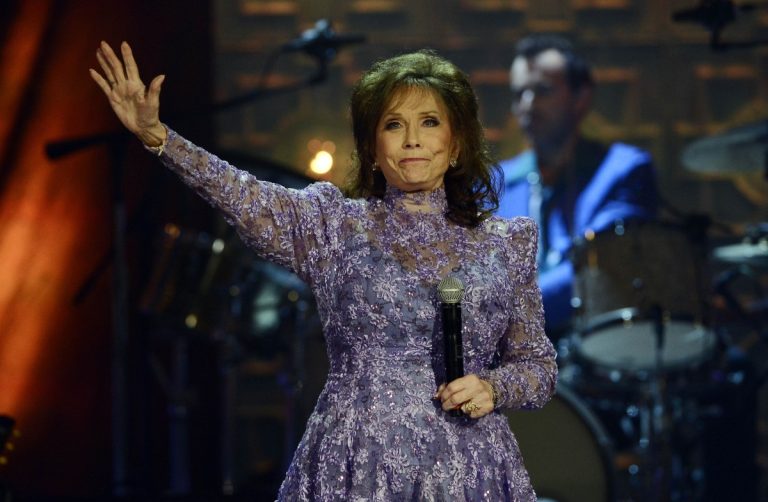 Loretta Lynn waves to the crowd after performing during the Americana Music Honors and Awards show Wednesday, Sept. 17, 2014, in Nashville, Tennessee. Lynn, the Kentucky coal miner’s daughter who became a pillar of country music, died on October 4, 2022, at her home in Hurricane Mills, Tennessee. She was 90. Photo: Mark Zaleski/AP Photo.