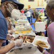A member of the Abundant Life Church serves barbeque chicken to an attendee of the dip dinner. About a dozen churches and faith communities partnered with several community organizations to prepare food for the event. Photo: Laura Harbert Allen/100 Days in Appalachia