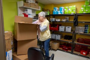 On June 6, 2025, Laura Jones goes through boxes of Easy Touch syringes to be distributed by Milan Puskar Health Right in Morgantown, W.Va., which operates one of only three syringe exchange programs in West Virginia. Photo by Ty McClung/West Virginia University